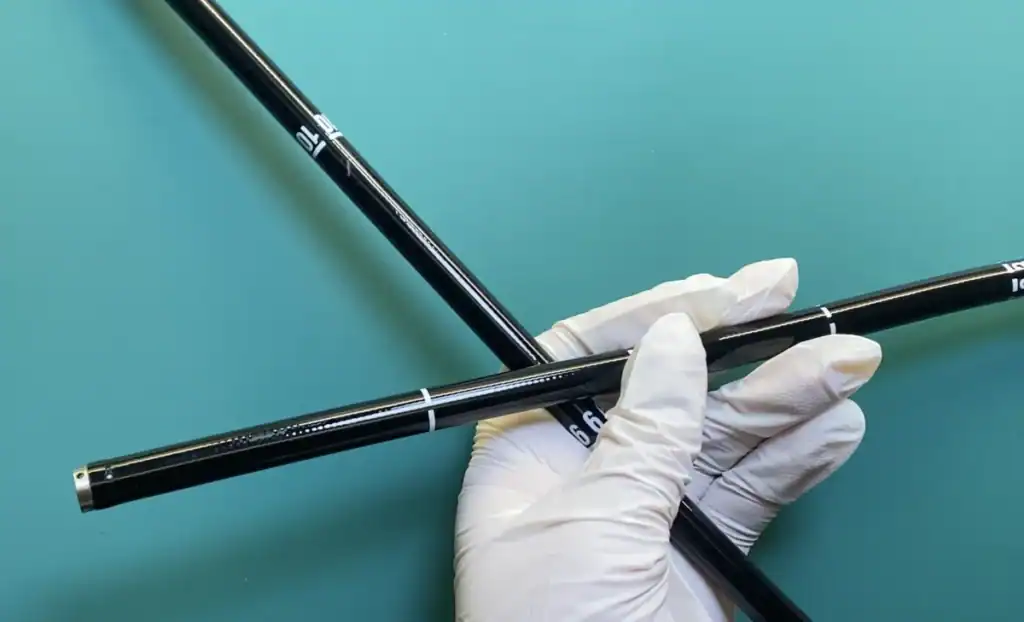 Endoscope insertion tubes quality inspection with gloved hand showing precision markings